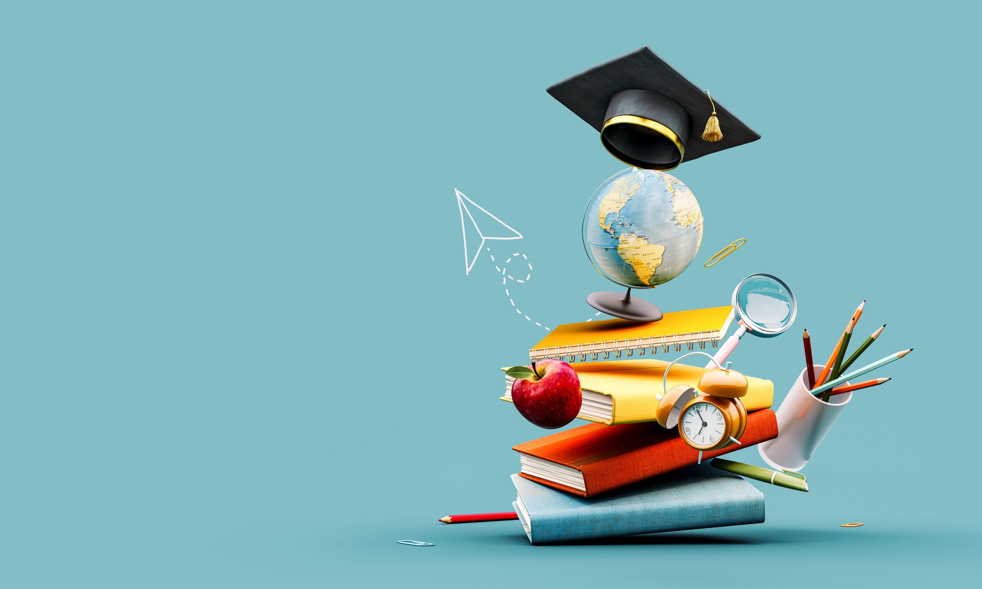 Globe with graduation hat and school accessory on blue background with copy space.